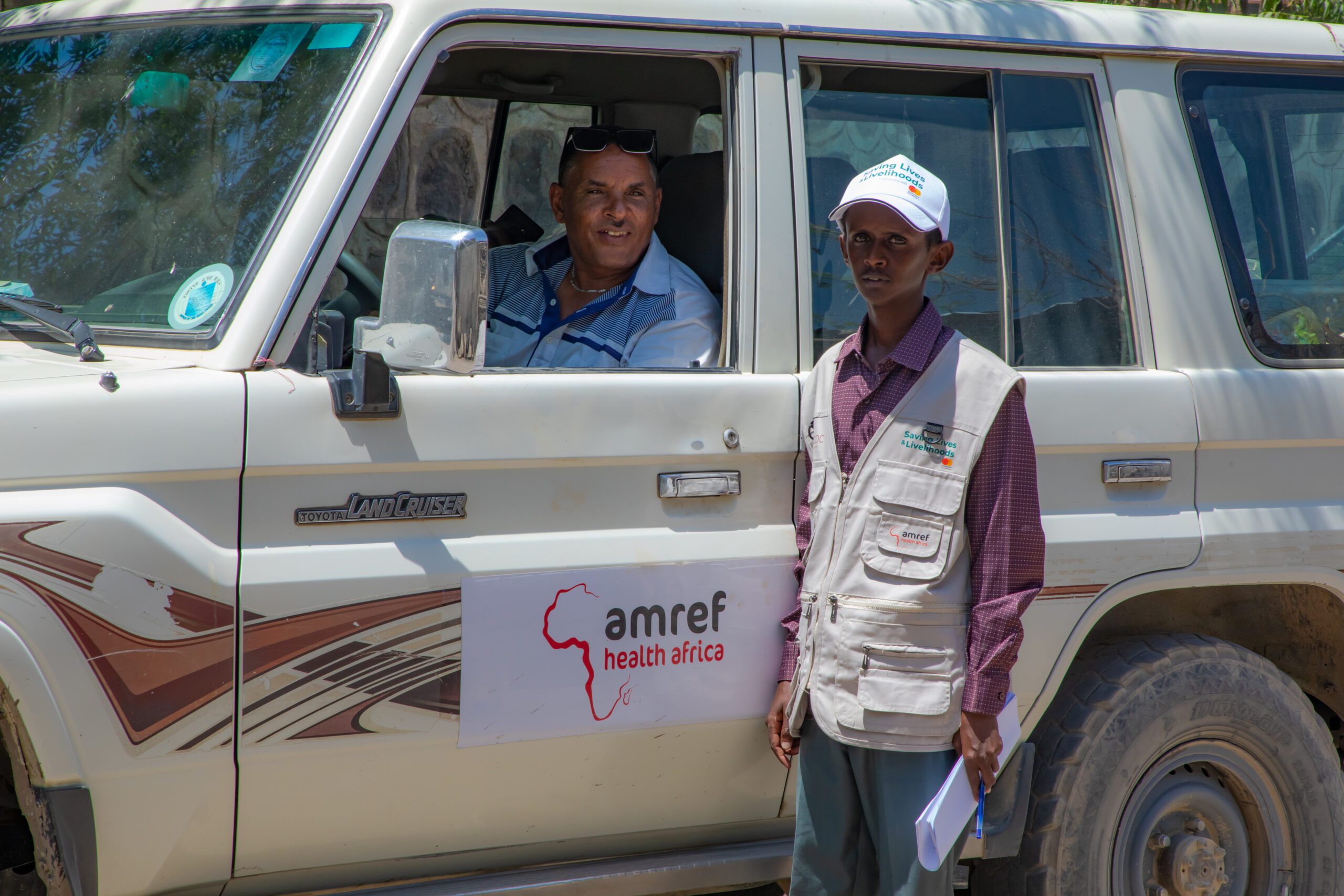 Mohammed Ahmed, Technical Assistant, Saving Lives and Livelihoods project in Afar Region – pausing with Amref driver in the remote village of Afar region