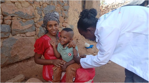 Philmon Haylome with his mother Kisanet Teklay, receives vaccination for the first time
